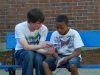 This boy was interested in listening to Tyler lead him through a gospel booklet.