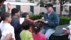 Glen sharing a gospel booklet with a number of kids.