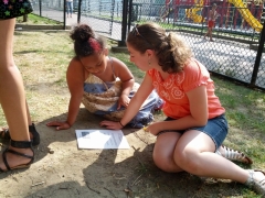 Vivienne saw that this little girl, Naoshi, needed help with her 'Lesson Sheet' that has questions based on the Bible lesson. Vivienne sat with Naoshi, read the questions, and helped Naoshi with them.