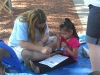 Brittney helping a young girl with her quiz based on the Bible lesson.